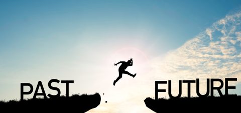 Go ahead and continuously improvement concept, silhouette man jump on a cliff from past to future with cloud sky background. Go ahead and continuously improvement concept, silhouette man jump on a cliff from past to future with cloud sky background.